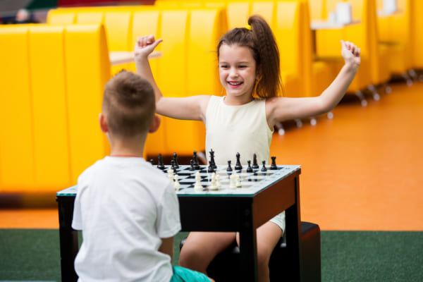 女の子と男の子がチェスで遊んでいる
