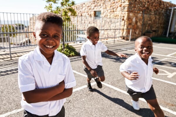 Young,African,Schoolboys,Running,In,School,Playground
